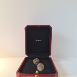 Cartier Double C cufflinks feature a silver sterling construction with a palladium finish and a sunray motif