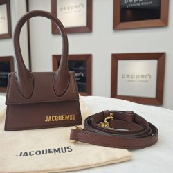 Jacquemus Le Chiquito mini bag featuring a gold-tone logo emblem.